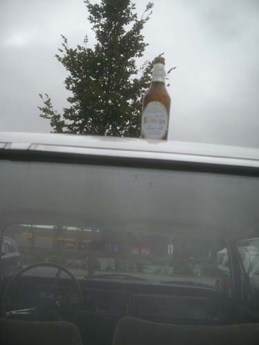 Bierflasche auf Autodach Bierflasche auf Autodach